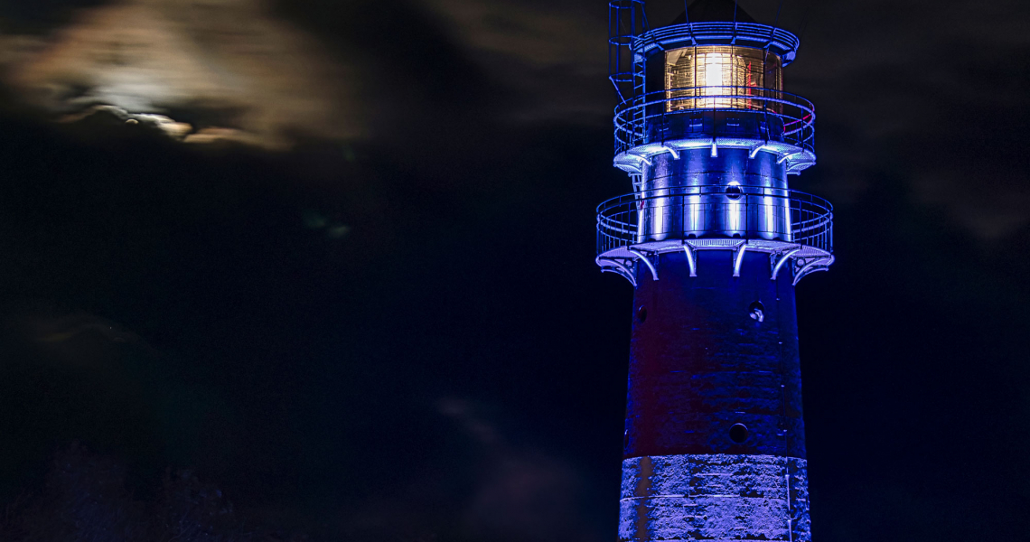 Blau beleuchteter Leuchtturm bei Nacht
